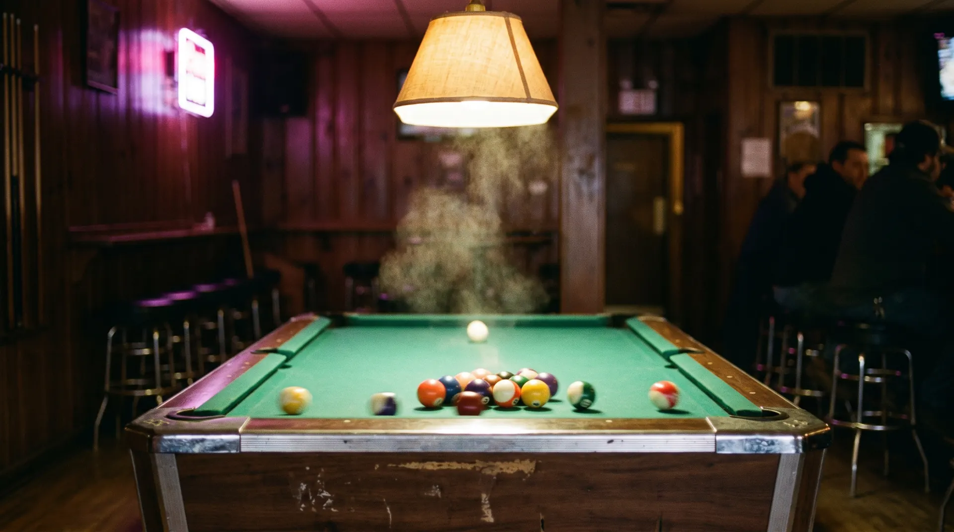 A pool break, balls scattering across the felt